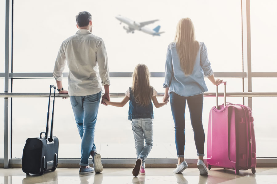 Travel Insurance - Family Walking Through the Airport
