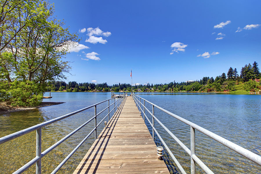 Lakewood, WA - View of Nature and Lake with Long Wood Pier on a Sunny Day
