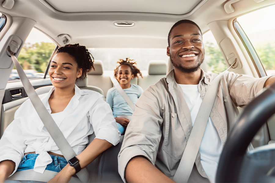 Car Insurance Quotes - Young Family Riding in a Car Together